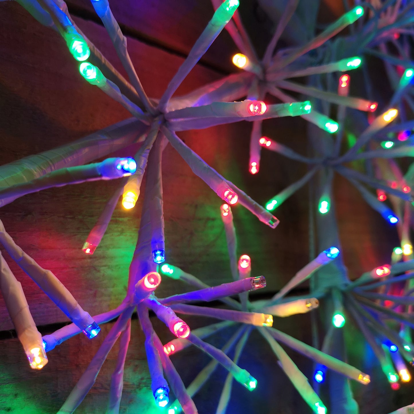 60cm Premier White Starburst Christmas Snowflake, Multi Coloured twinkling lights.