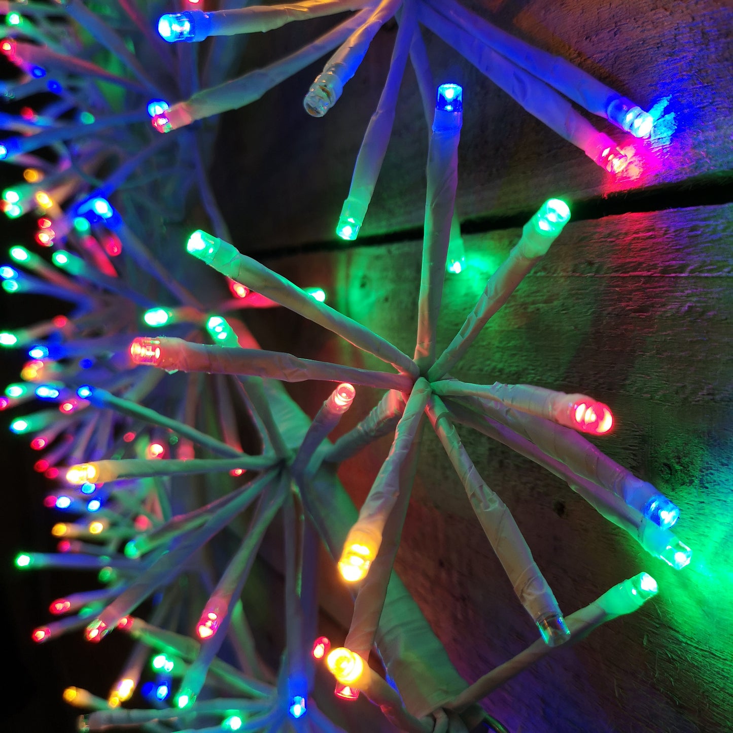 60cm Premier White Starburst Christmas Snowflake, Multi Coloured twinkling lights.